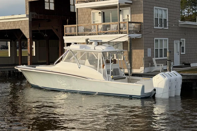 Slide: The Image of 2026 Albemarle 45 Carolinian Fisharound Express docked by a waterfront building. - 1