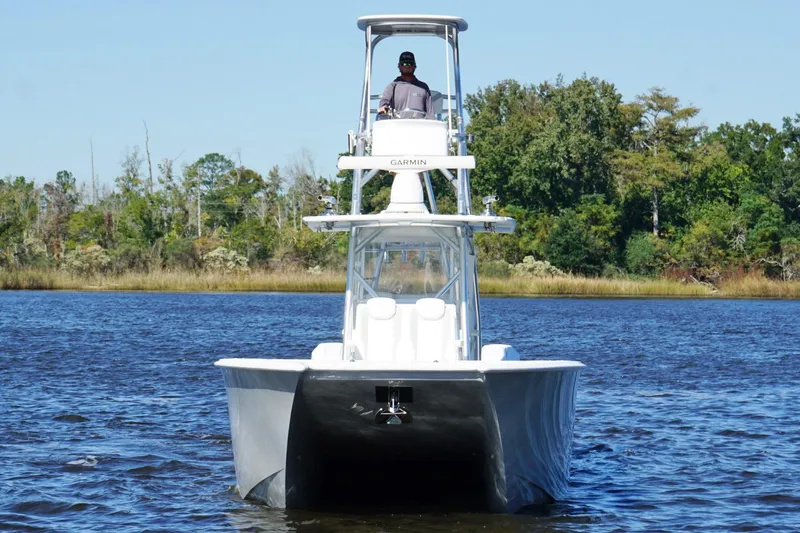 Slide: The Image of 2020 Custom HHH 35LX Catamaran on water, with lush green shoreline background. - 10