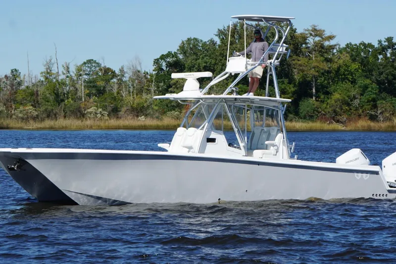 Slide: The Image of Custom HHH 35LX Catamaran 2020 on water, featuring sleek design and dual outboard engines. - 11