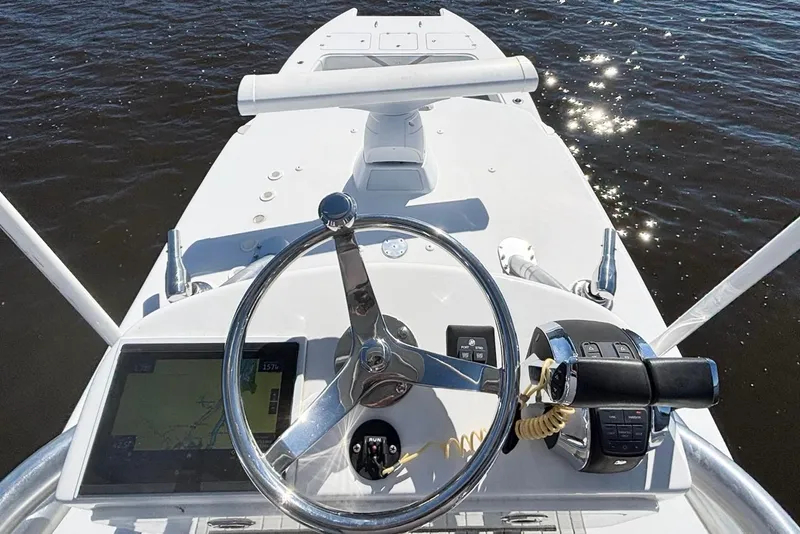 Slide: The Image of Helm of 2020 Custom HHH 35LX Catamaran with steering wheel and controls, on water. - 12