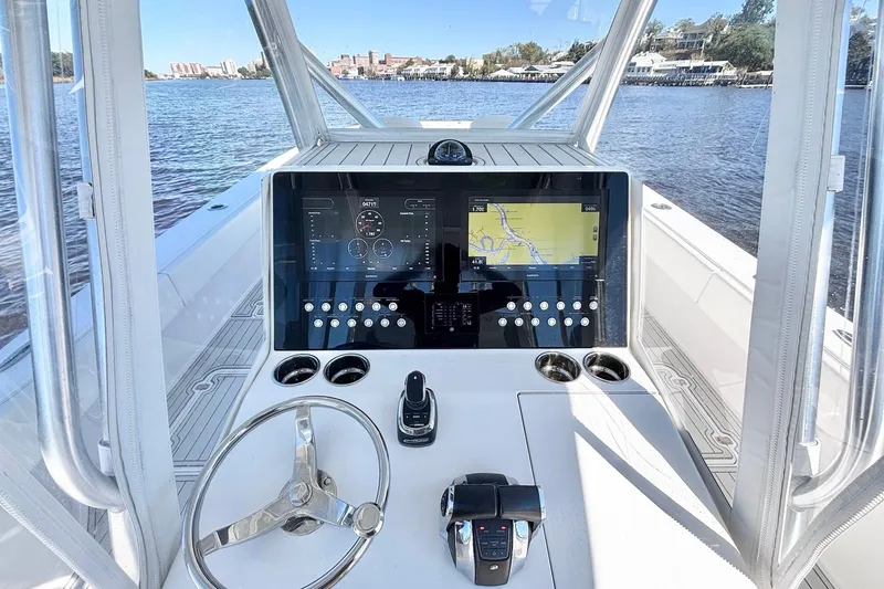 Slide: The Image of Cockpit view of 2020 Custom HHH 35LX Catamaran with navigation display and steering wheel. - 18