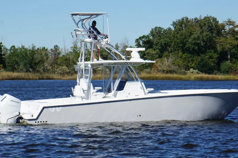 Slide: The Image of Custom HHH 35LX Catamaran 2020 cruising on a calm river with lush green trees. - 5