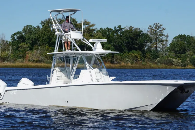 Slide: The Image of 2020 Custom HHH 35LX Catamaran cruising on a lake with lush green trees in the background. - 6