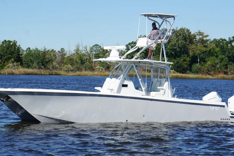 Slide: The Image of Custom HHH 35LX Catamaran 2020 on calm water, featuring sleek design and dual outboard engines. - 7