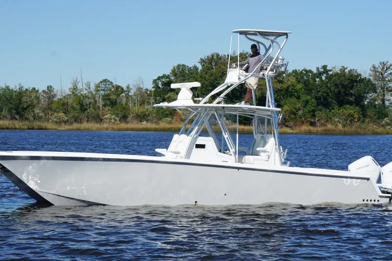 Slide: The Image of Custom HHH 35LX Catamaran 2020 on water, featuring elevated helm and twin engines. - 9