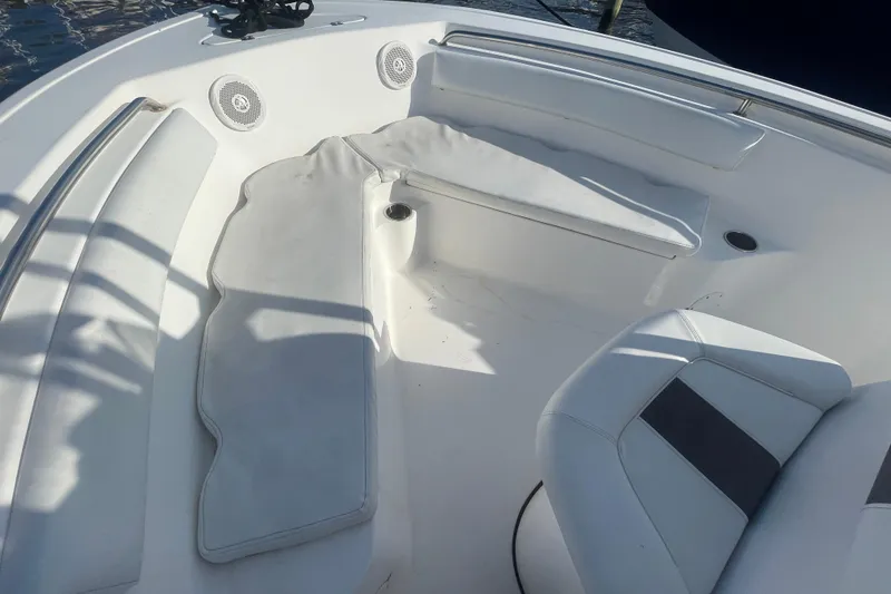 Slide: The Image of 2013 Tidewater 210 LXF boat interior with cushioned seating and speakers. - 10