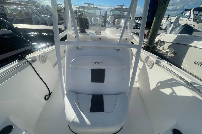Slide: The Image of 2013 Tidewater 210 LXF boat interior with seating, docked at marina. - 11