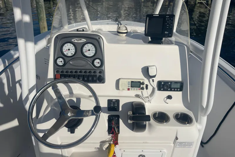 Slide: The Image of Steering console of a 2013 Tidewater 210 LXF boat with gauges and controls. - 13