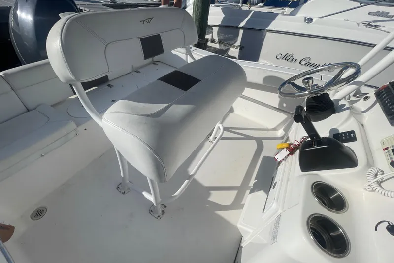 Slide: The Image of 2013 Tidewater 210 LXF boat interior with steering wheel and seating area. - 18