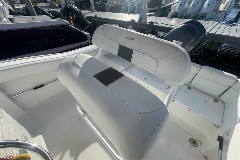 Slide: The Image of 2013 Tidewater 210 LXF boat interior with seating and docked at marina. - 19