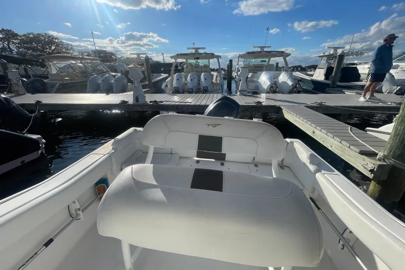 Slide: The Image of Tidewater 210 LXF 2013 boat docked at marina under clear blue sky. - 20