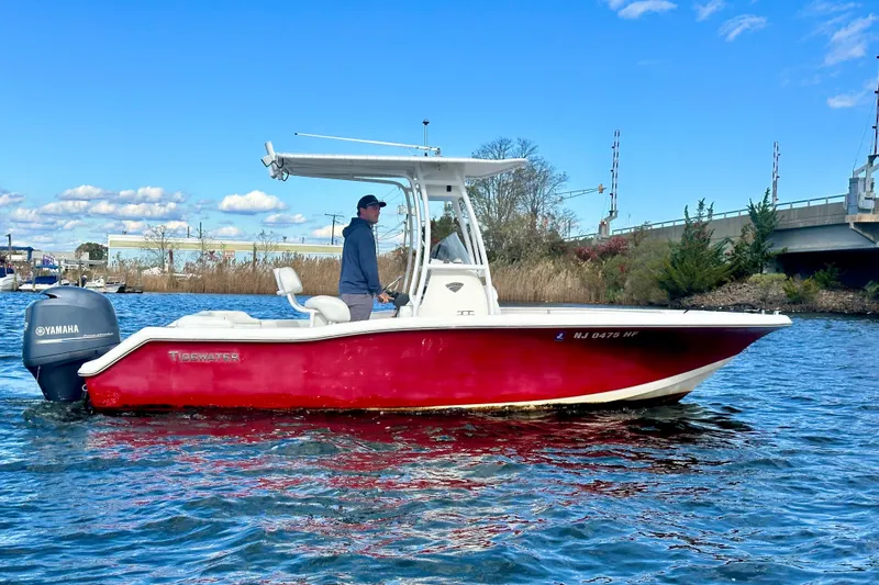 Slide: The Image of 2013 Tidewater 210 LXF boat with Yamaha engine on a sunny day. - 6