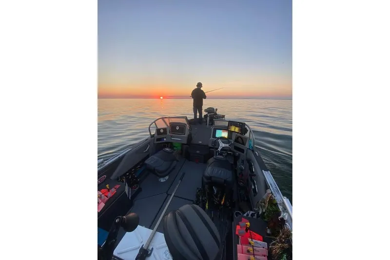 Slide: The Image of 2022 Ranger 622FS Pro boat at sunset with person fishing on calm water. - 6