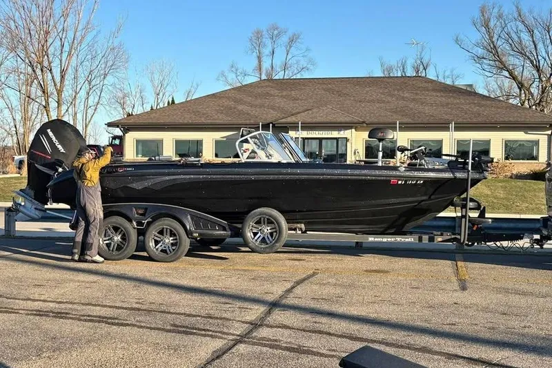 Slide: The Image of 2022 Ranger 622FS Pro Touring boat on trailer, parked near a building. - 7