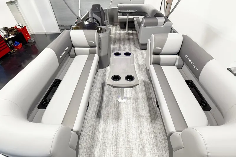 Slide: The Image of 2025 Bennington 21S Cruise interior with gray seating and cup holders. - 11