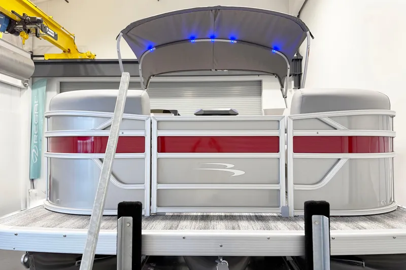 Slide: The Image of 2025 Bennington 21S Cruise pontoon boat with canopy and LED lights in a showroom. - 3