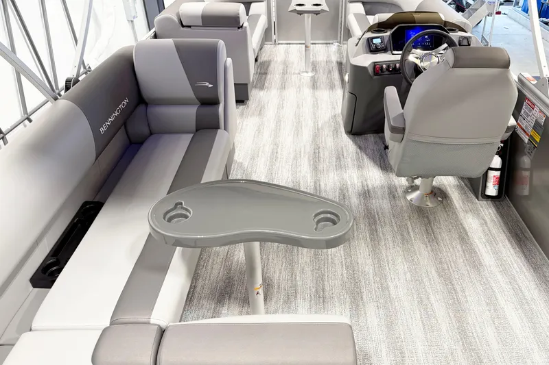 Slide: The Image of 2025 Bennington 21S Cruise interior with gray seating, steering console, and table. - 5