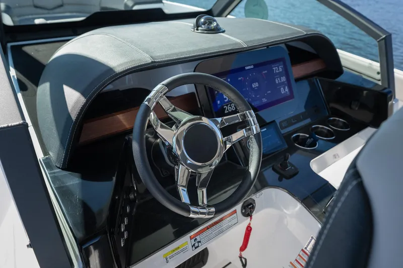 Slide: The Image of 2026 Monterey Elite 27 SD boat dashboard with modern steering and digital display. - 11