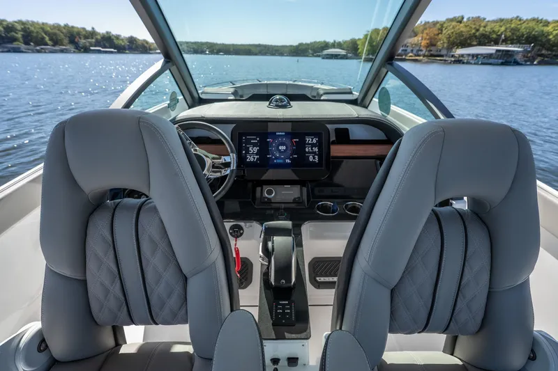 Slide: The Image of Interior view of 2026 Monterey Elite 27 SD boat, featuring modern dashboard and luxurious seating. - 13
