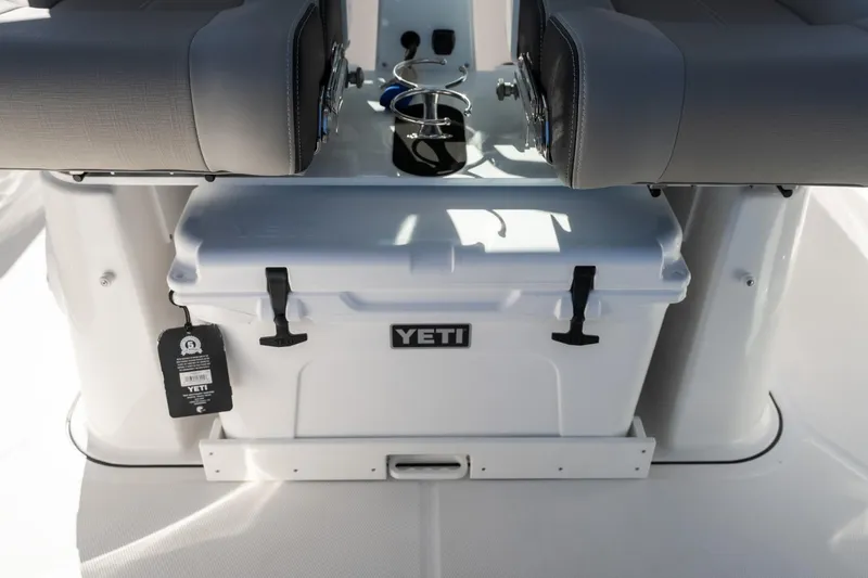 Slide: The Image of YETI cooler on 2026 Monterey Elite 27 SD boat, under gray seats. - 15