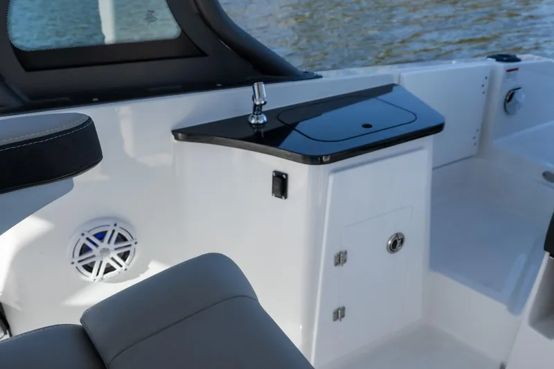 Slide: The Image of 2026 Monterey Elite 27 SD boat interior with sleek black countertop and modern design. - 17