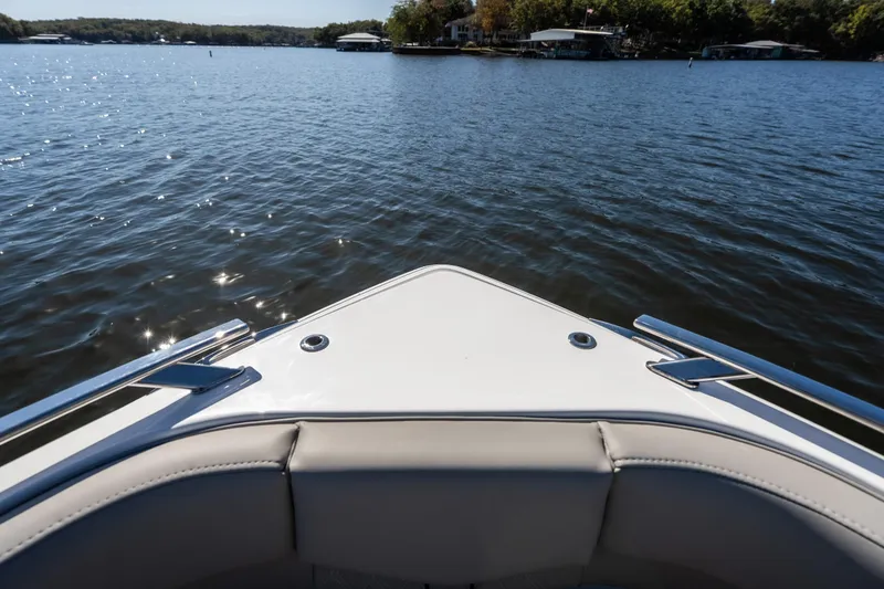 Slide: The Image of Bow view of 2026 Monterey Elite 27 SD boat on a serene lake. - 21