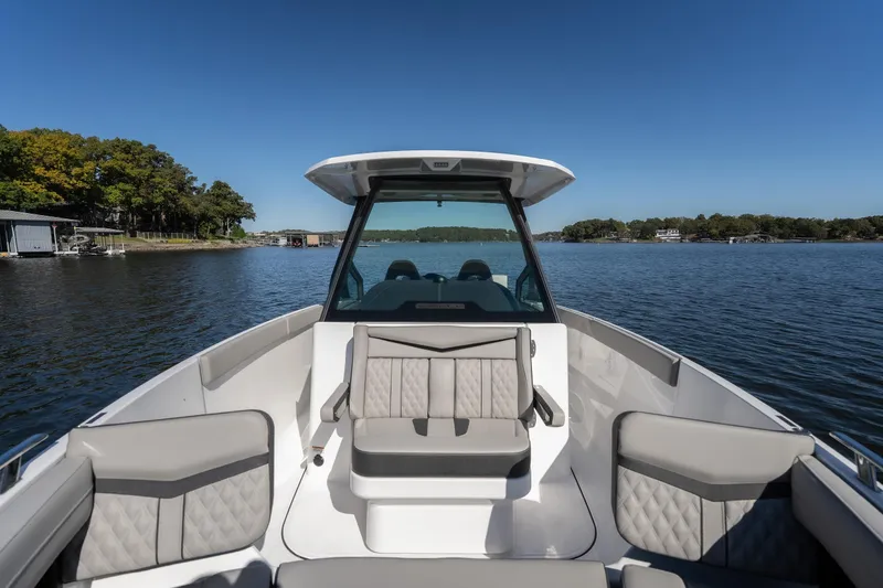 Slide: The Image of 2026 Monterey Elite 27 SD boat on a serene lake with clear blue skies. - 22