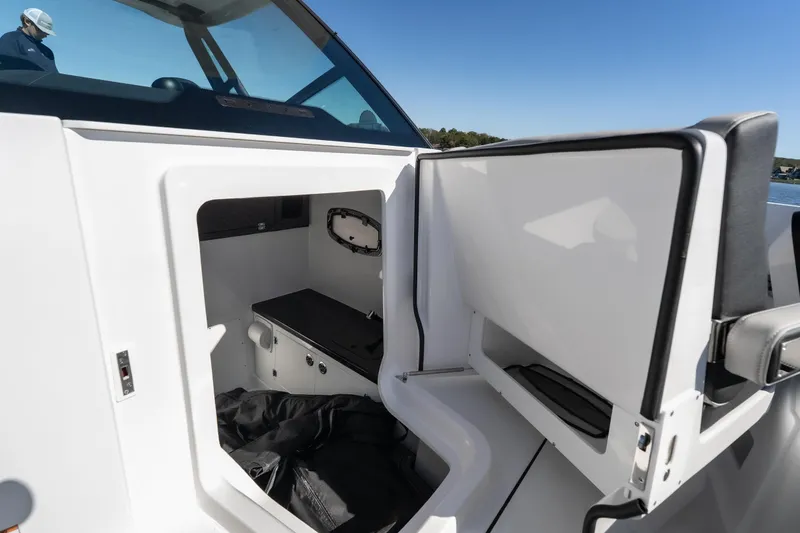 Slide: The Image of 2026 Monterey Elite 27 SD boat interior storage compartment with open hatch. - 26