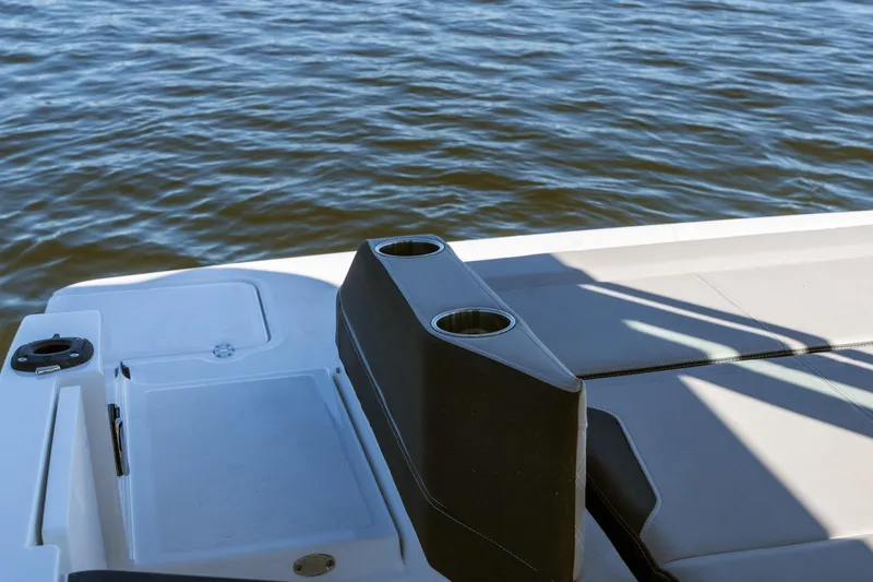 Slide: The Image of 2026 Monterey Elite 27 SD boat deck with cup holders, near water. - 29