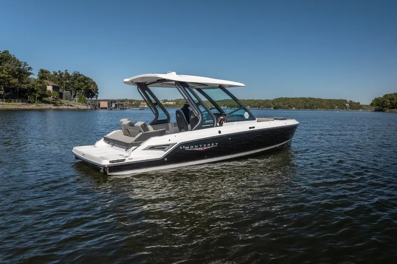 Slide: The Image of 2026 Monterey Elite 27 SD boat on a serene lake under clear blue skies. - 36