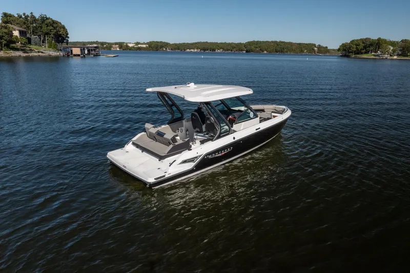 Slide: The Image of 2026 Monterey Elite 27 SD boat on a serene lake under clear blue skies. - 37