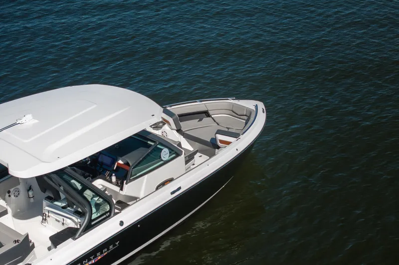 Slide: The Image of 2026 Monterey Elite 27 SD boat on calm water, showcasing sleek design and spacious seating. - 39
