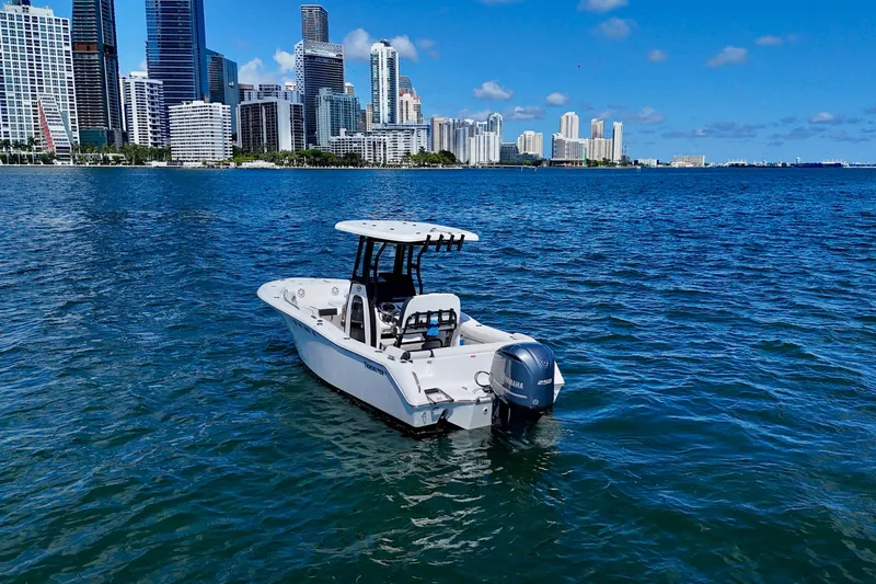 The Image of 2023 Tidewater 232 LXF boat on water with city skyline in background. - 0