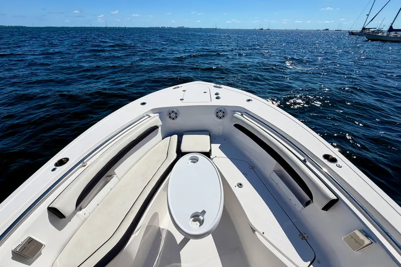 Slide: The Image of 2023 Tidewater 232 LXF boat interior with seating, on a sunny day at sea. - 14