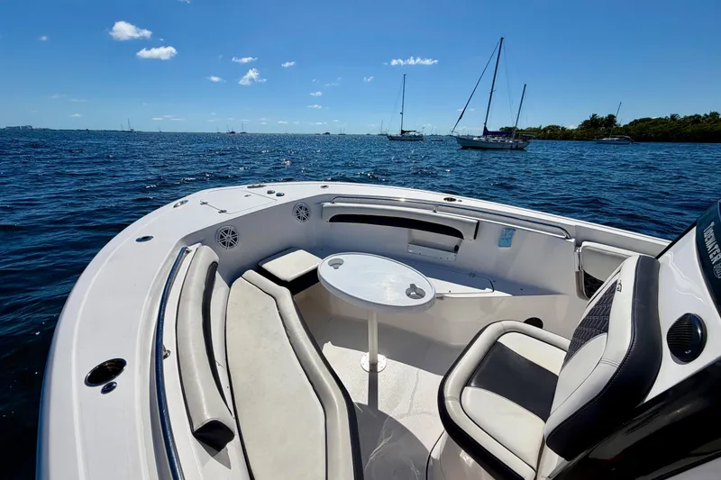 Slide: The Image of 2023 Tidewater 232 LXF boat interior with seating and table on open water. - 15