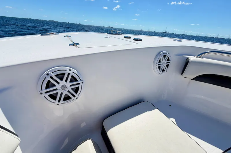 Slide: The Image of 2023 Tidewater 232 LXF boat interior with speakers, ocean view, and clear sky. - 17
