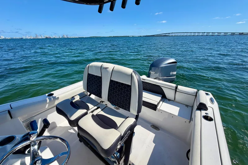 Slide: The Image of 2023 Tidewater 232 LXF boat on open water with Yamaha engine, clear blue sky. - 20