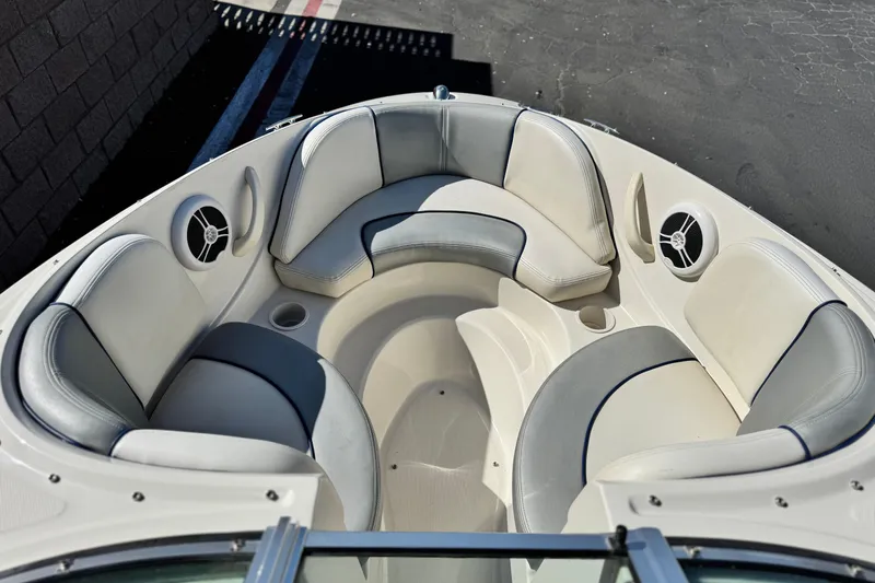 Slide: The Image of 2006 Bayliner 215 Bowrider boat interior with cushioned seating and speakers. - 12