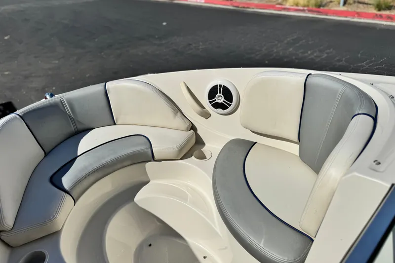 Slide: The Image of 2006 Bayliner 215 Bowrider boat interior with cushioned seating and speaker. - 14