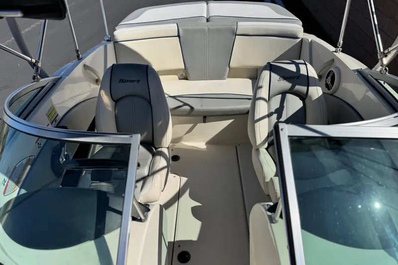 Slide: The Image of 2006 Bayliner 215 Bowrider interior with white seating and windshield view. - 15