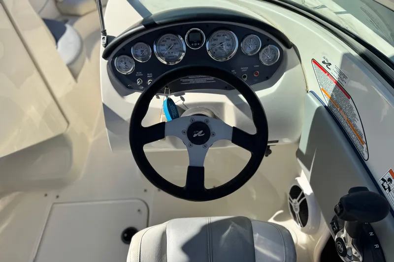 Slide: The Image of 2006 Bayliner 215 Bowrider dashboard with steering wheel and instrument panel. - 24