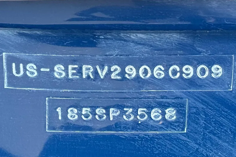 Slide: The Image of 2006 Bayliner 215 Bowrider hull identification number and serial number on blue surface. - 28