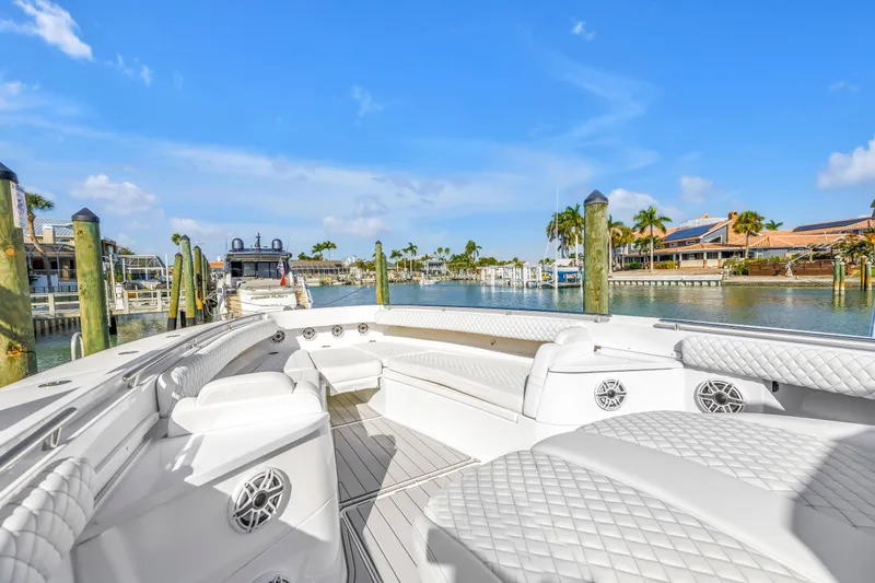 Slide: The Image of 2023 HCB 53 Suenos RXV luxury boat docked in a sunny marina setting. - 104