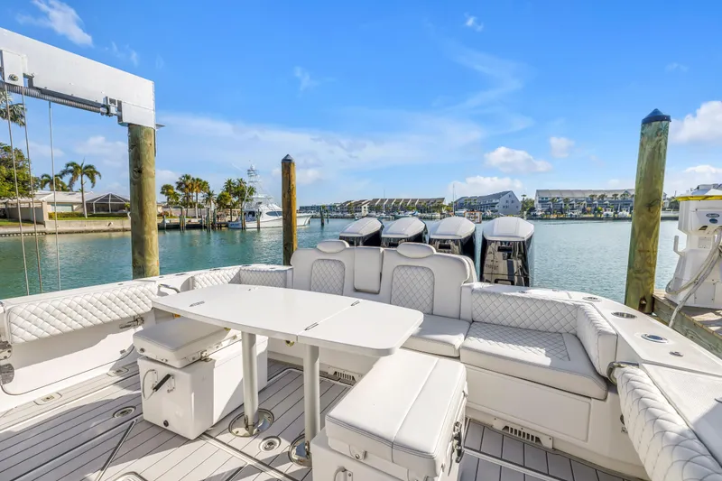 Slide: The Image of 2023 HCB 53 Suenos RXV luxury boat docked with elegant seating and scenic waterfront view. - 108