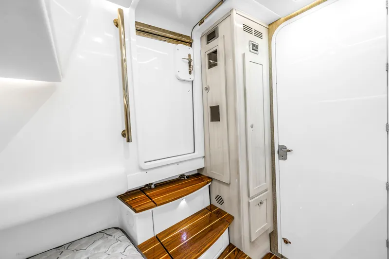 Slide: The Image of Interior of 2023 HCB 53 Suenos RXV yacht with wooden steps and white cabinetry. - 123