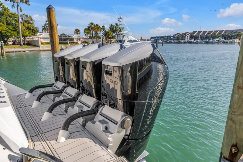Slide: The Image of 2023 HCB 53 Suenos RXV boat with four powerful outboard engines docked in marina. - 130