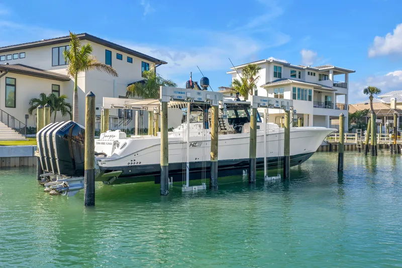 Slide: The Image of 2023 HCB 53 Suenos RXV boat docked near waterfront homes. - 21