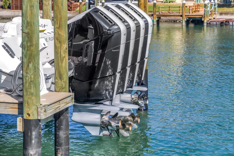 Slide: The Image of 2023 HCB 53 Suenos RXV boat engines docked on clear water. - 24