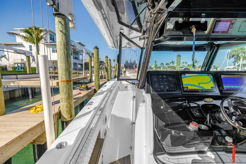 Slide: The Image of 2023 HCB 53 Suenos RXV boat interior with advanced navigation system at a marina. - 36