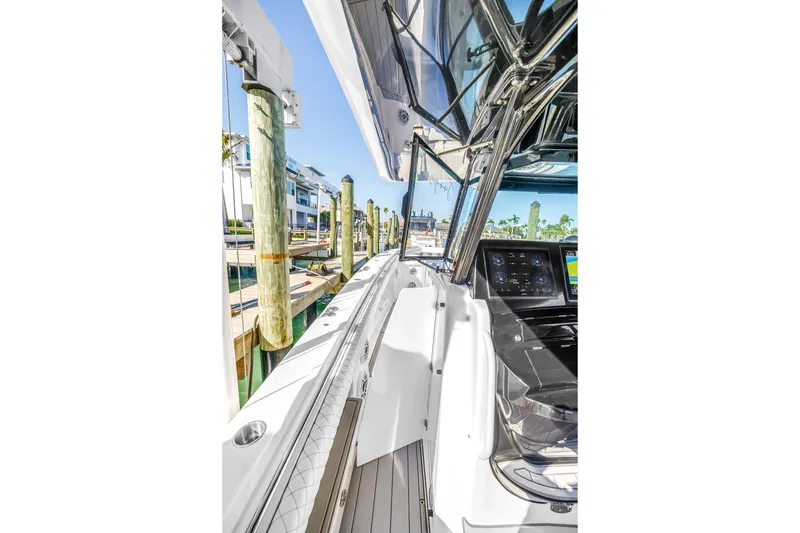 Slide: The Image of 2023 HCB 53 Suenos RXV boat docked, showcasing sleek design and advanced navigation controls. - 39